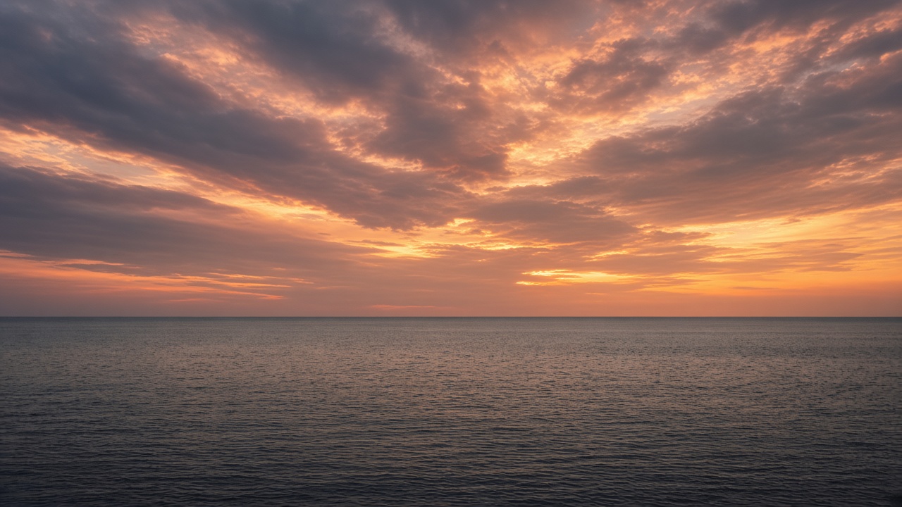 The same open sea at dusk with the horizon on the lower third and a larger, more dramatic sky